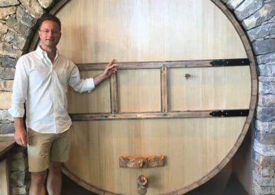 Provence Wine Tours - Brice, wine guide,in front of a cask in a Bandol winery