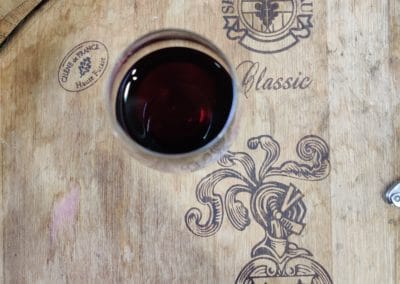 Provence Wine Tours - Glass of red on a cask
