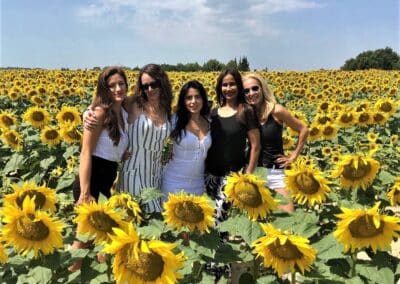 Provence Wine Tours - A group of hosts on a private wine tour posing in a sunflower field